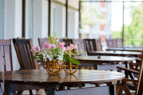 cafe on a sunny day with flowers on the table