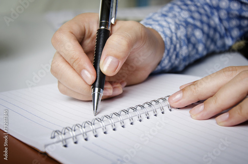 Closeup of secretary's hand doing paperwork © psphotography