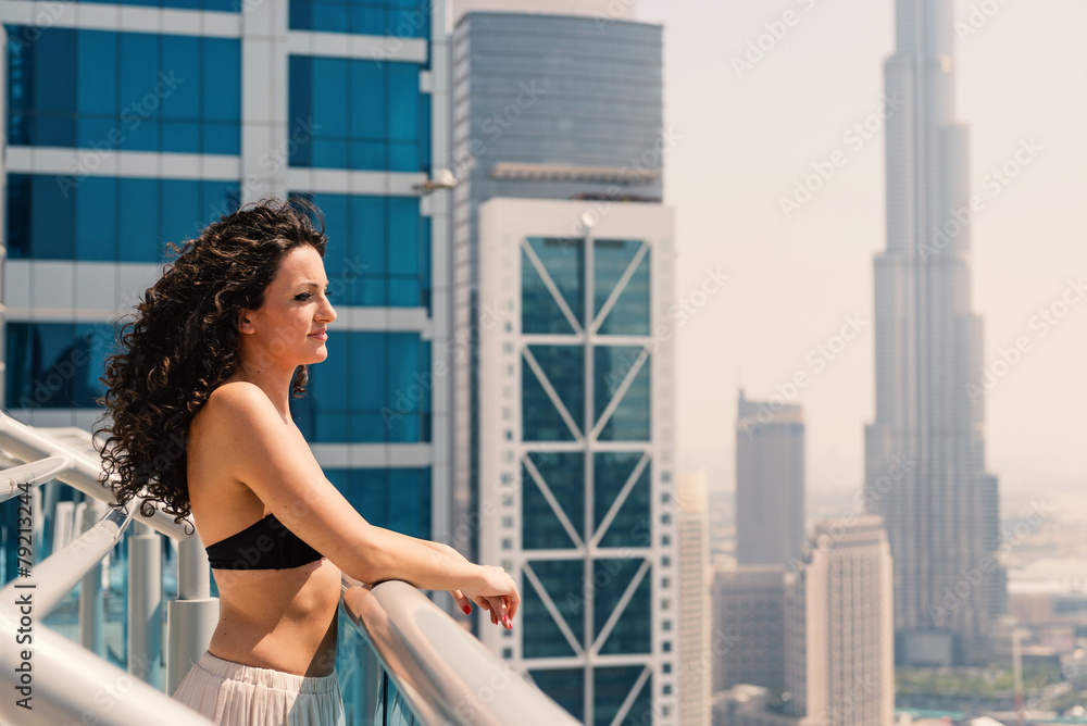 Fototapeta premium Young woman portrait wearing bikini sunbathing in swimming pool
