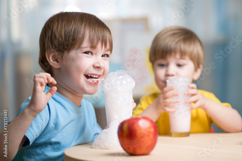 children drinking milk at home