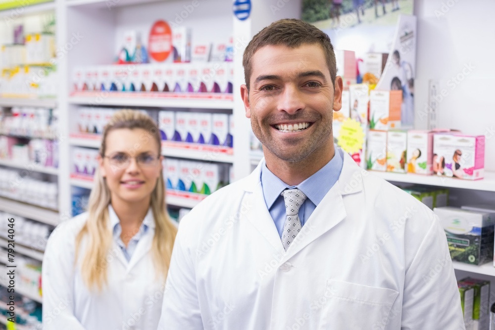 Team of pharmacists smiling at camera Team of pharmacists smiling at camera