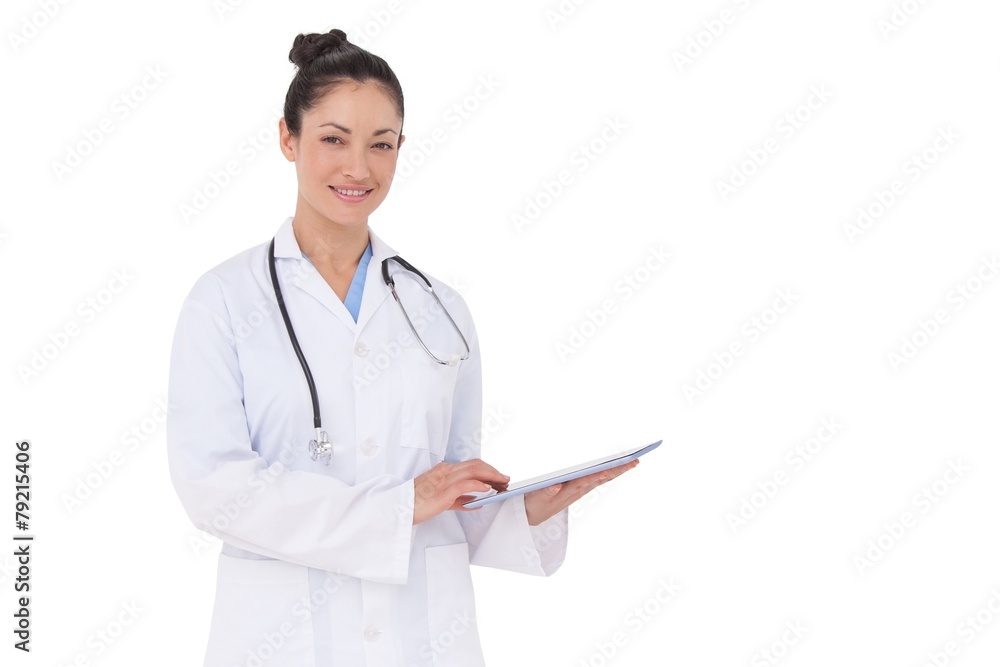 Happy doctor using her tablet pc Happy doctor using her tablet pc