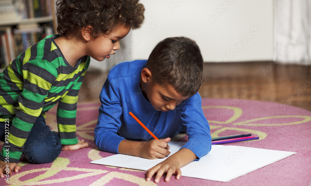 custom made wallpaper toronto digitalYoung mixed race boys drawing on paper with crayon.
