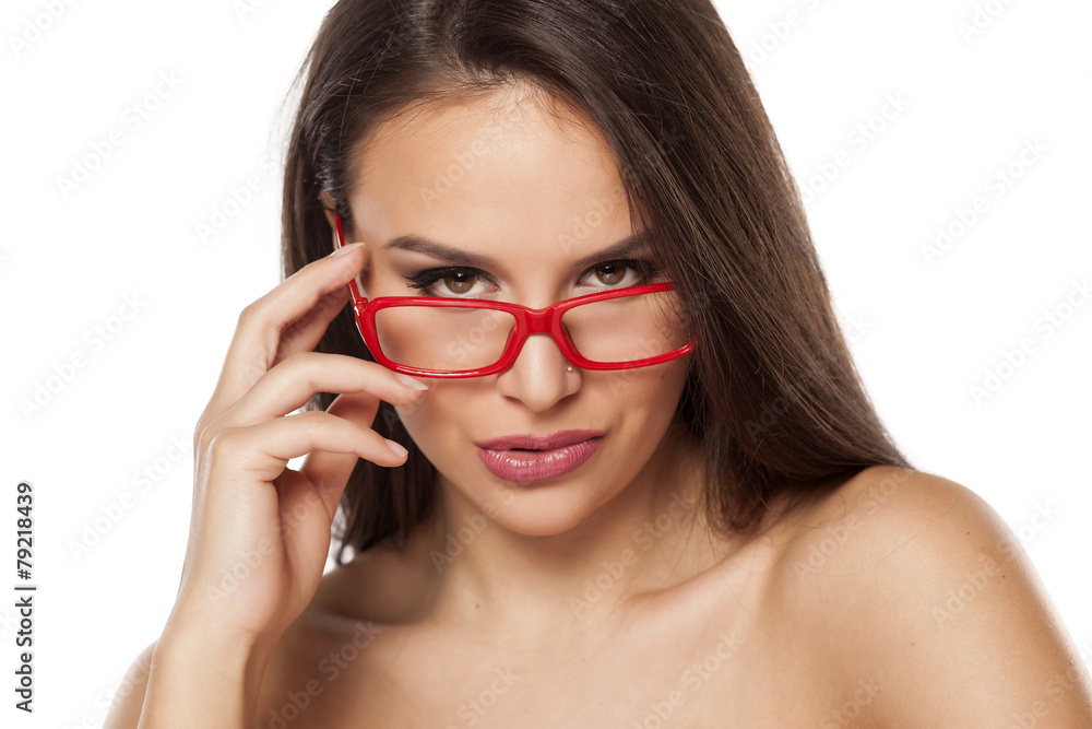 beautiful young woman looking over her glasses beautiful young woman looking over her glasses