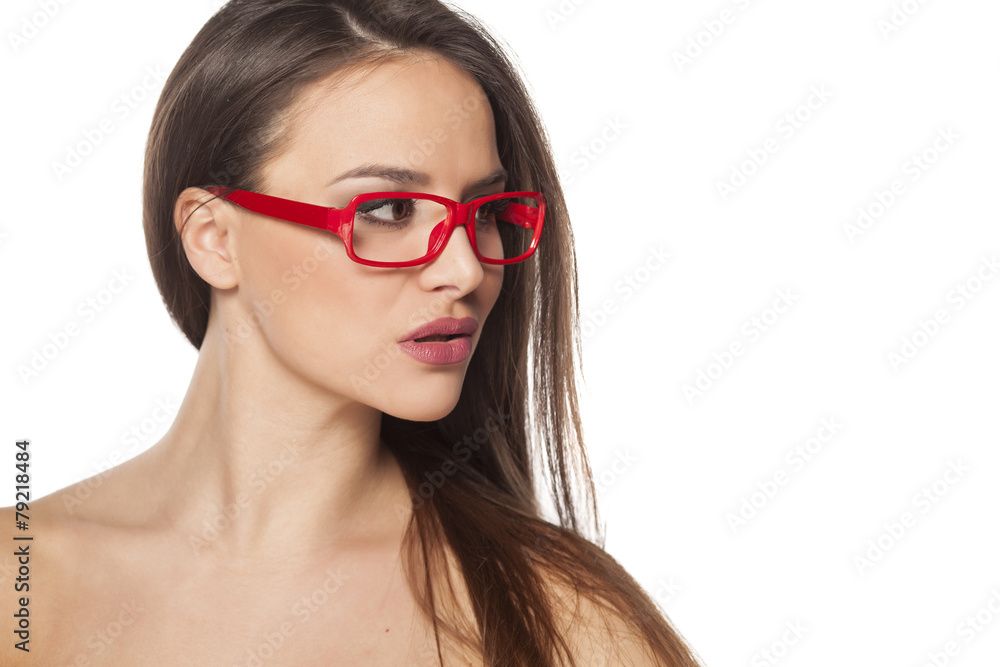 pretty young woman with glasses posing on a white background