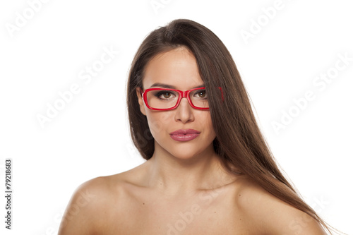 pretty young woman with glasses posing on a white background