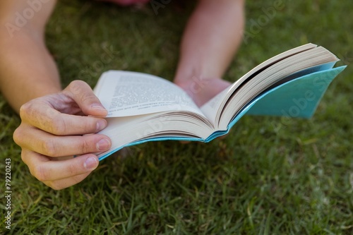 Pretty woman reading book in park