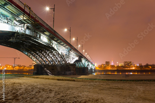 Poniatowski bridge over Vistula river illuminated in Warsaw