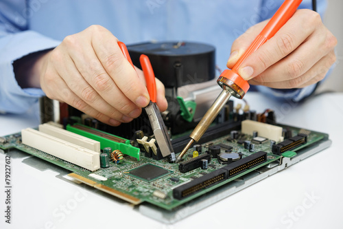 Ταπετσαρία Computer  technician is changing capacitor on faulty motherboard