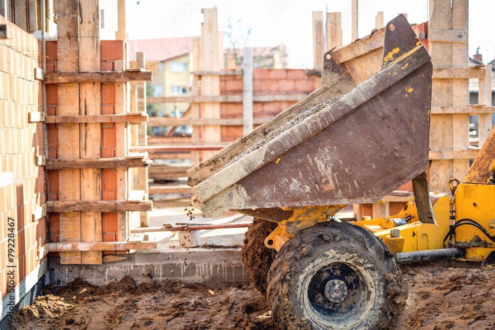 Fototapeta premium Dumper truck unloading gravel, sand and stones at construction