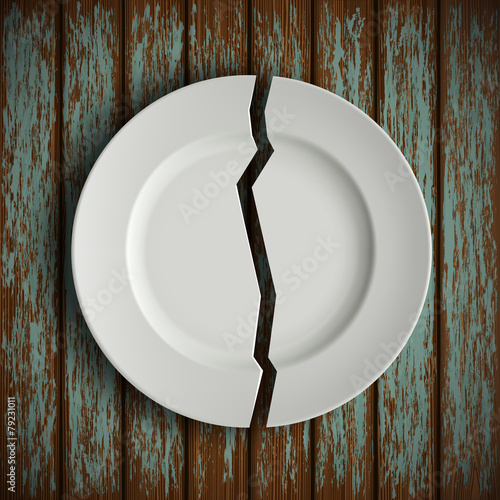 broken white plate on old wooden table