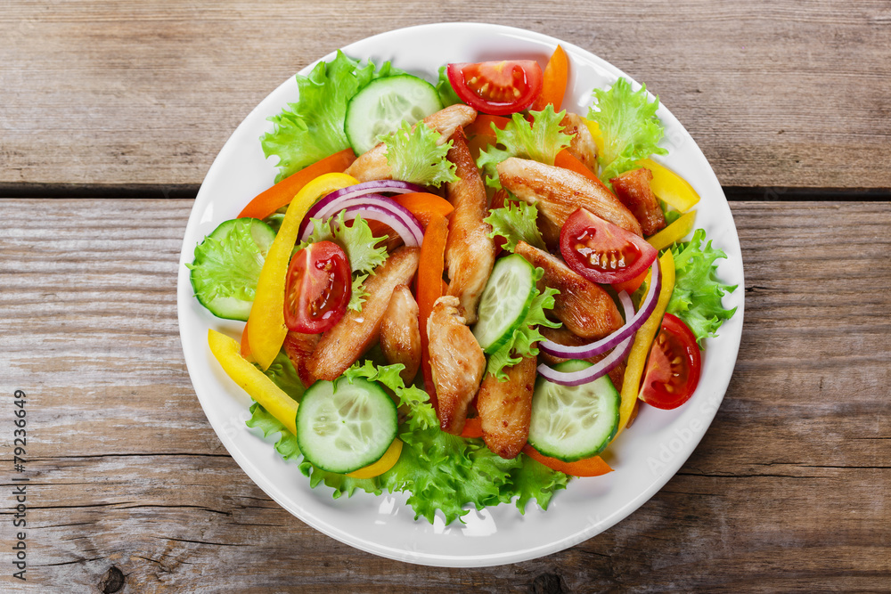 Salad with grilled chicken fillet tomatoes peppers and cucumber Salad with grilled chicken fillet tomatoes peppers and cucumber
