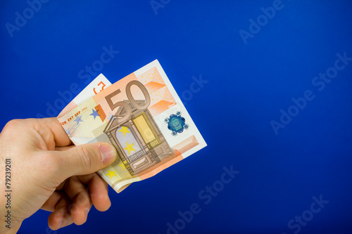 hand holding out a banknote