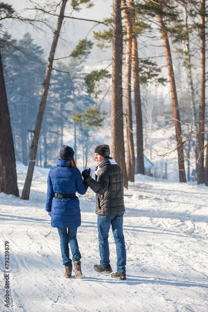 Couple walking in winter forest Couple walking in winter forest