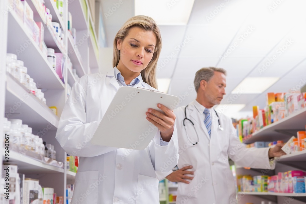 Young trainee writing on a prescription pad Young trainee writing on a prescription pad