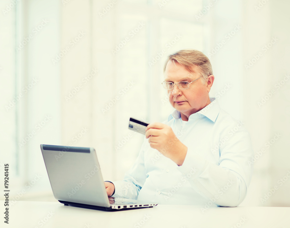 old man with laptop and credit card at home old man with laptop and credit card at home