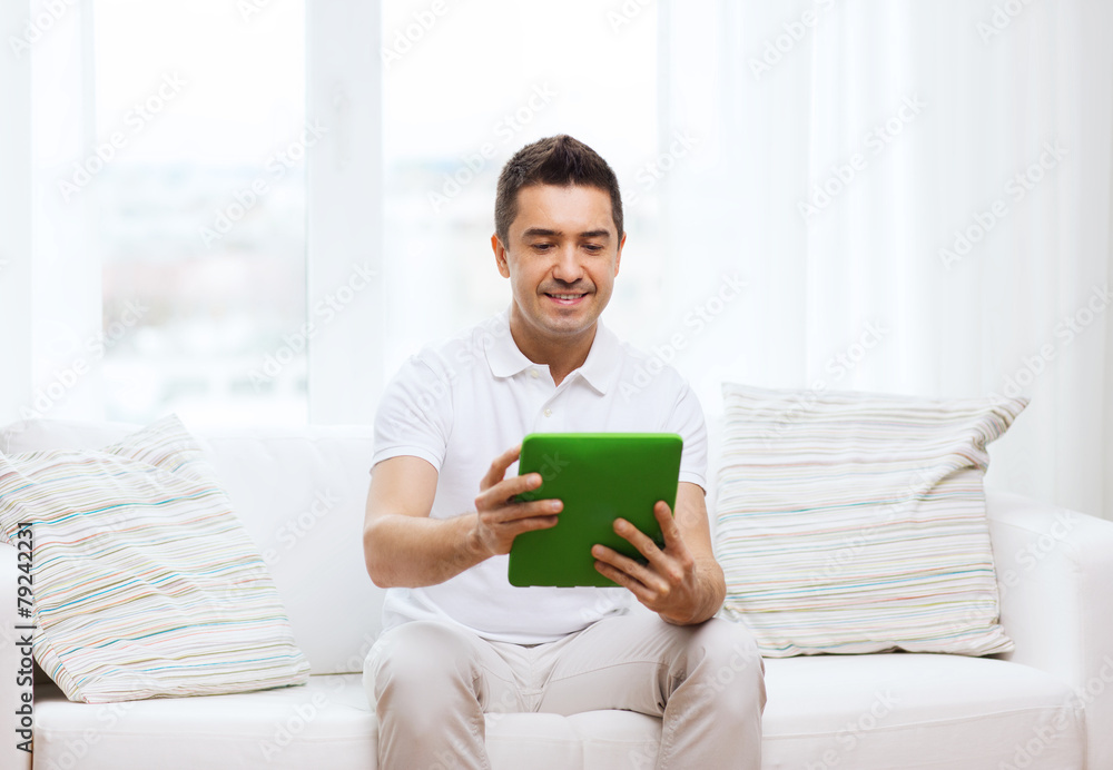 smiling man working with tablet pc at home smiling man working with tablet pc at home