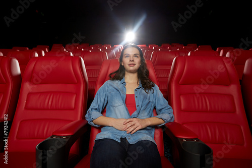 young woman watching movie in theater