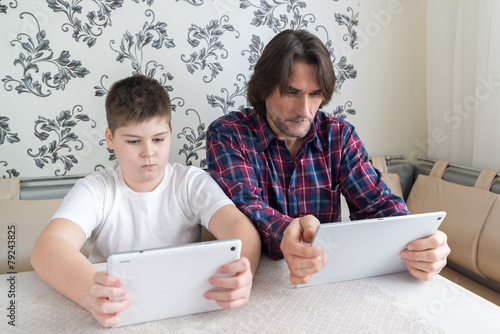 dad and son   with tablet computer indoor