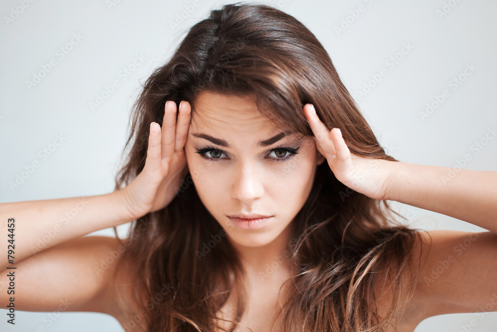The girl touches with hands temples The girl touches with hands temples