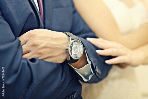 newlyweds hands during wedding watch concept