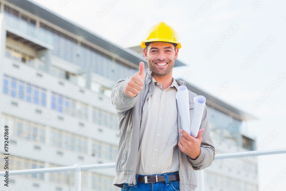 Architect with blueprints gesturing thumbs up outdoors Architect with blueprints gesturing thumbs up outdoors
