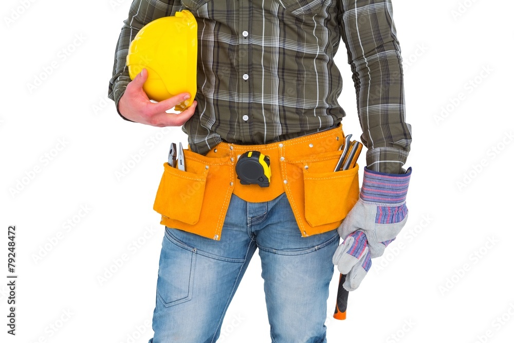 Manual worker wearing tool belt while holding gloves and helmet Manual worker wearing tool belt while holding gloves and helmet