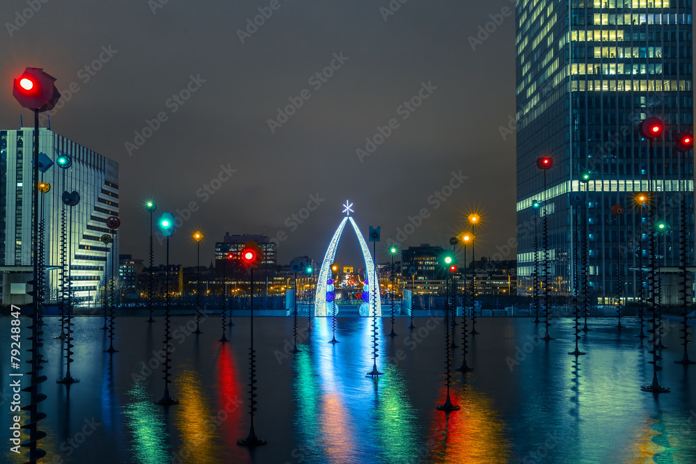Multicolored fountain in the Esplanade De La Defense at night