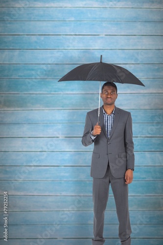 Wallpaper Mural Composite image of businessman standing under umbrella Torontodigital.ca