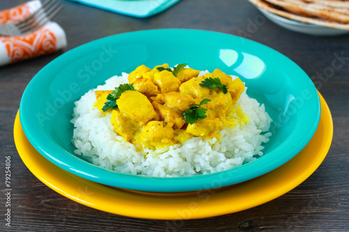 Chicken curry with rice on wooden table