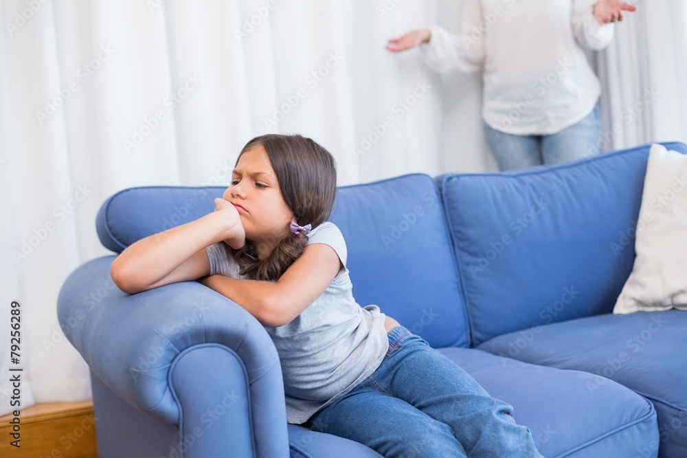 Angry little girl sitting on the couch Angry little girl sitting on the couch