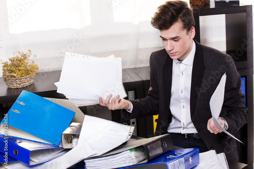 Business man have so many paperwork in the office
