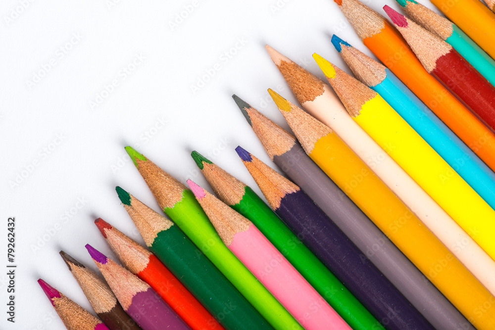 Several color pencils on a white paper sheet Several color pencils on a white paper sheet