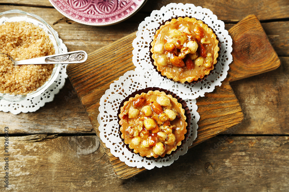 Mini cakes with nuts on wooden background Mini cakes with nuts on wooden background