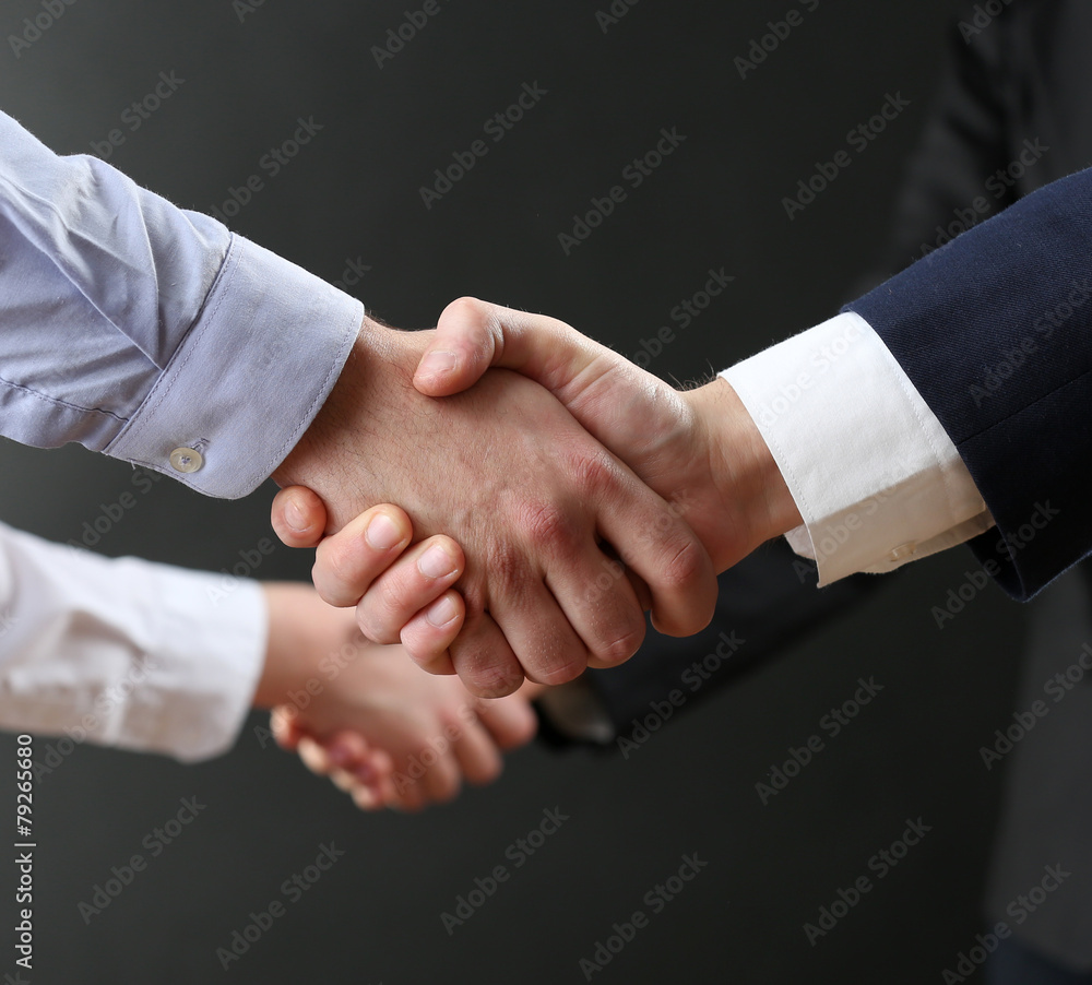 Business handshake on dark background Business handshake on dark background