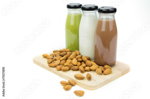 Almond milk in glass bottles  with almonds