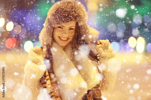 winter night portrait of a beautiful girl, snowflakes, fur hat