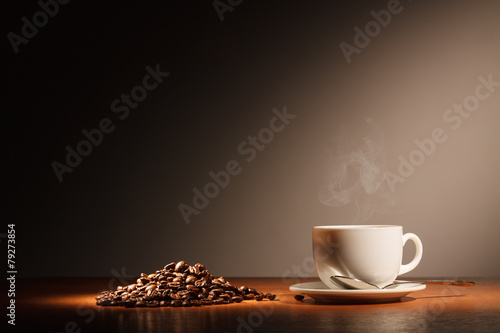 Coffee cup with steam and coffee beans