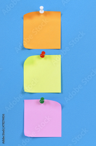 Vertical row or line of post it sticky note pinned to blue background photo