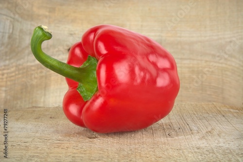 Studio shot of red bell pepper isolated on wooden board