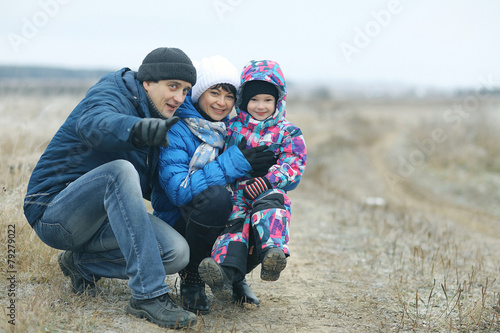 family with two children in the winter on the nature