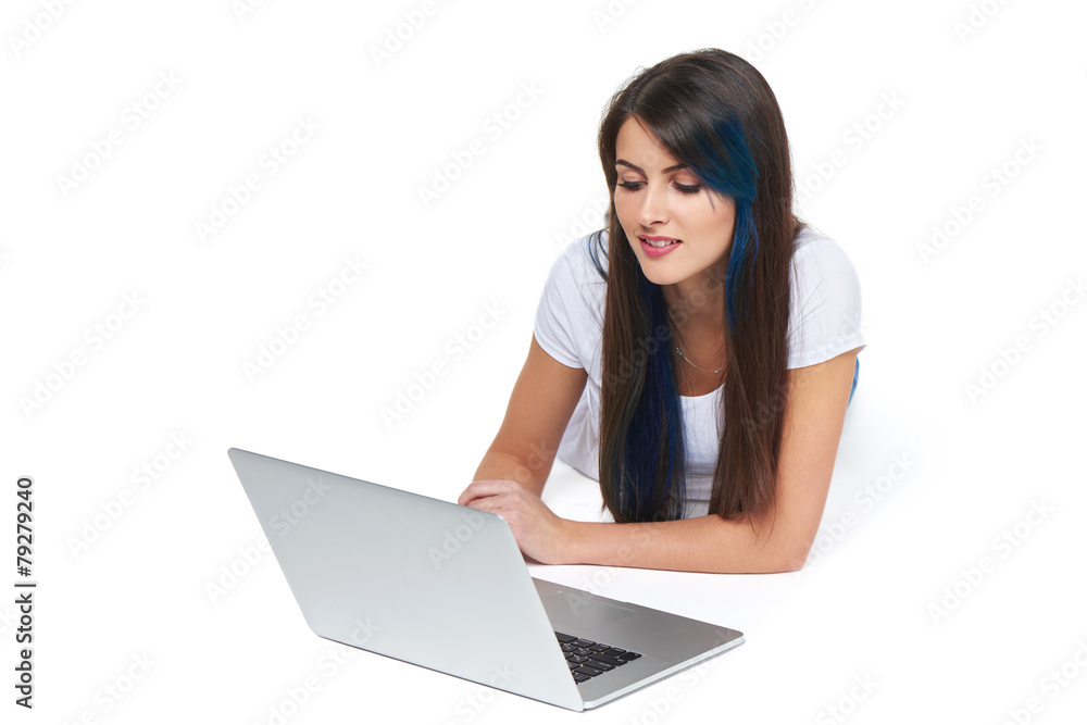 Woman lying on the floor with laptop Woman lying on the floor with laptop