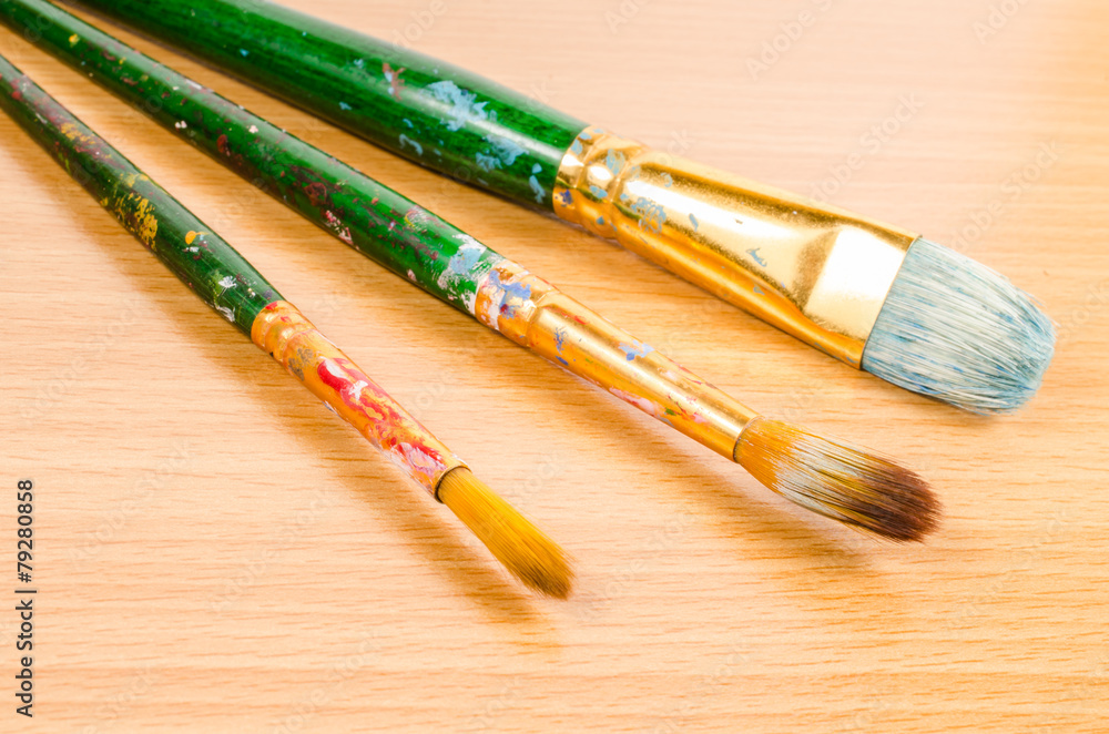 Fototapeta premium artist paintbrush on wooden table