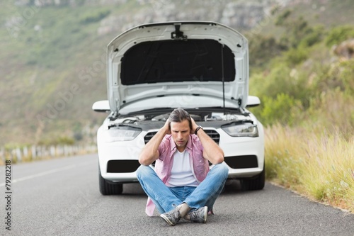 Stressed man sitting after a car breakdown © WavebreakMediaMicro