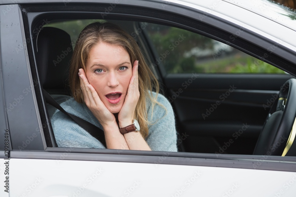 Shocked woman sitting in drivers seat