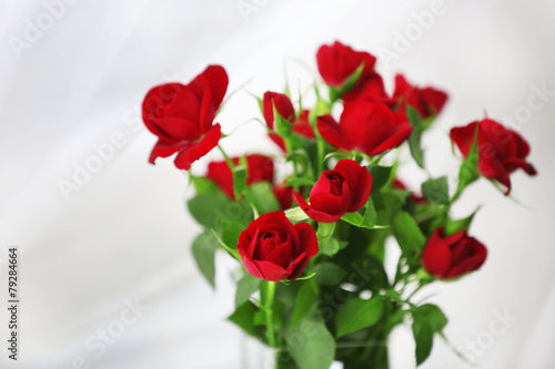Bouquet of red roses on blurred background