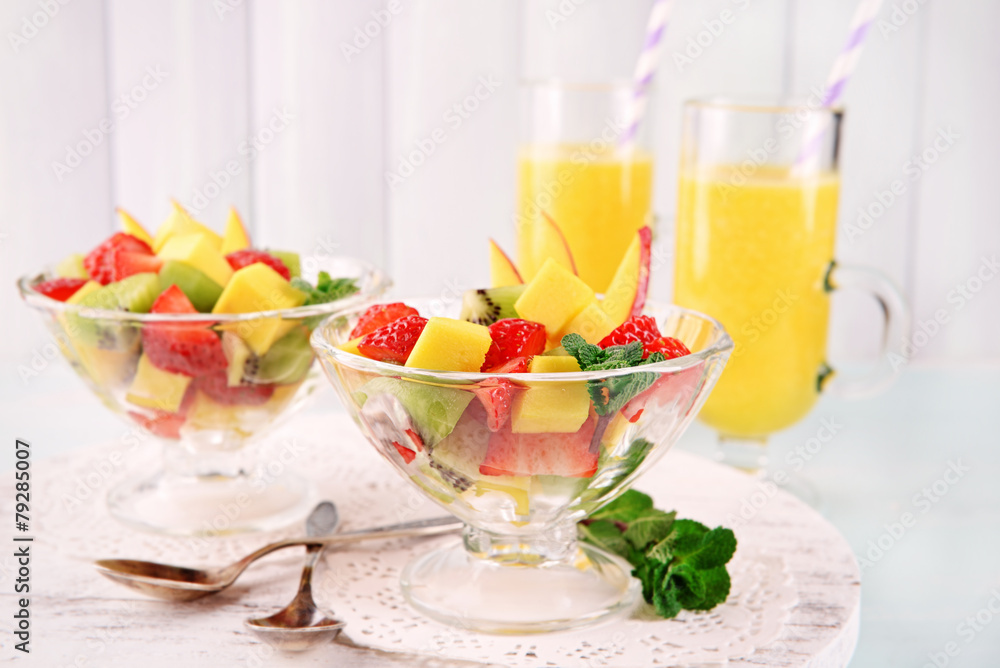 Fruit salad with mint and orange juice in glassware Fruit salad with mint and orange juice in glassware