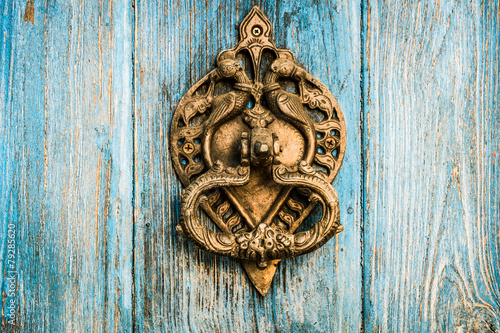 Vintage brass door knocker on wooden door