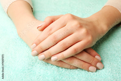 Beautiful female hands on fabric background