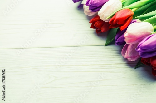 Colorful tulips on wooden table